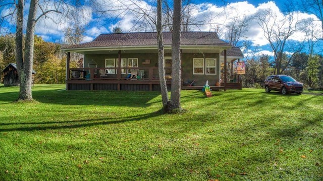 back of property with a porch and a lawn