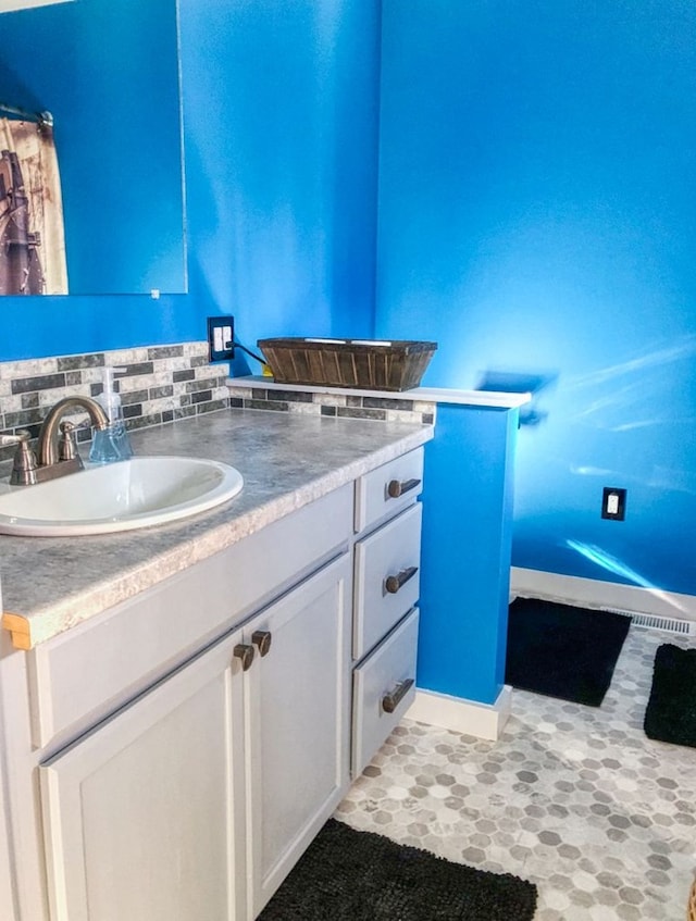 bathroom with decorative backsplash and vanity