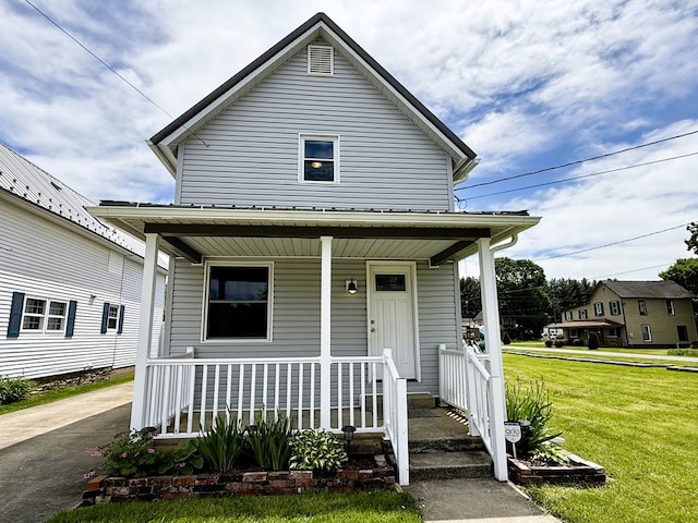 113 1st St, Shinglehouse, PA 16748 - view of front of house featuring covered porch and a front lawn