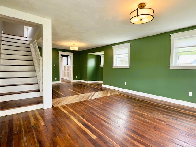 113 1st St, Shinglehouse, PA 16748 - spare room featuring baseboards, stairs, and hardwood / wood-style flooring