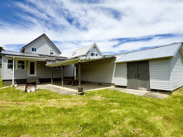 113 1st St, Shinglehouse, PA 16748 - rear view of house with entry steps, a yard, metal roof, and a patio area