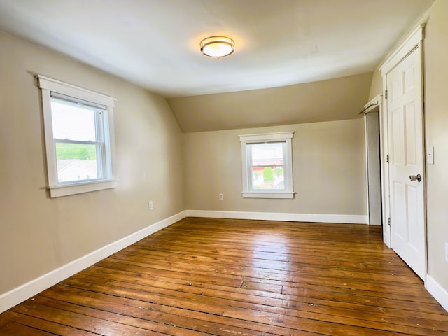 113 1st St, Shinglehouse, PA 16748 - unfurnished bedroom with hardwood / wood-style floors, multiple windows, vaulted ceiling, and baseboards