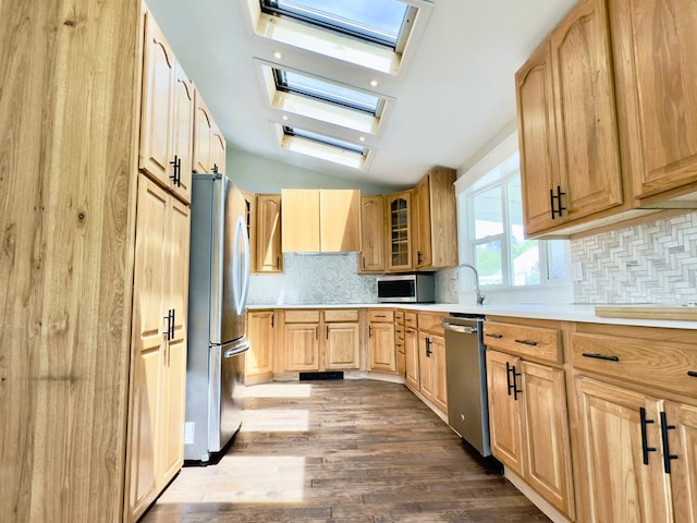 113 1st St, Shinglehouse, PA 16748 - kitchen with a skylight, appliances with stainless steel finishes, light brown cabinetry, dark wood finished floors, and decorative backsplash