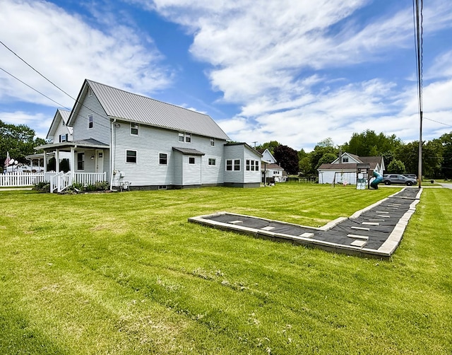 113 1st St, Shinglehouse, PA 16748 - rear view of house featuring a lawn and metal roof