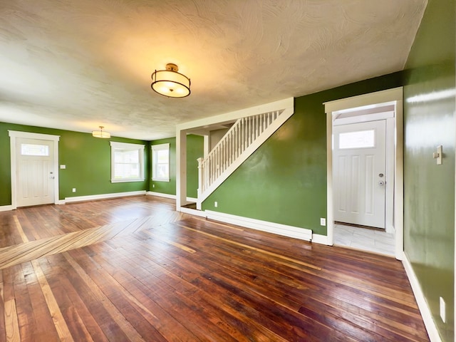 113 1st St, Shinglehouse, PA 16748 - unfurnished living room featuring stairway, baseboards, and wood-type flooring