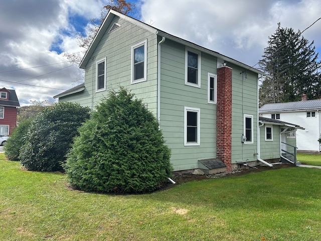 rear view of house with a yard