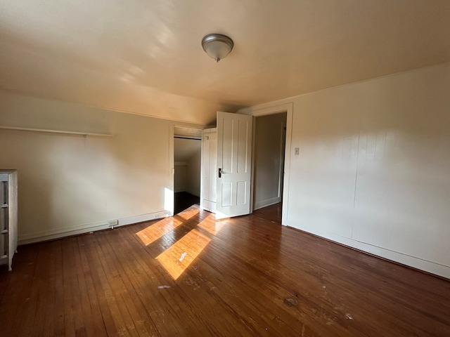 additional living space with dark hardwood / wood-style flooring