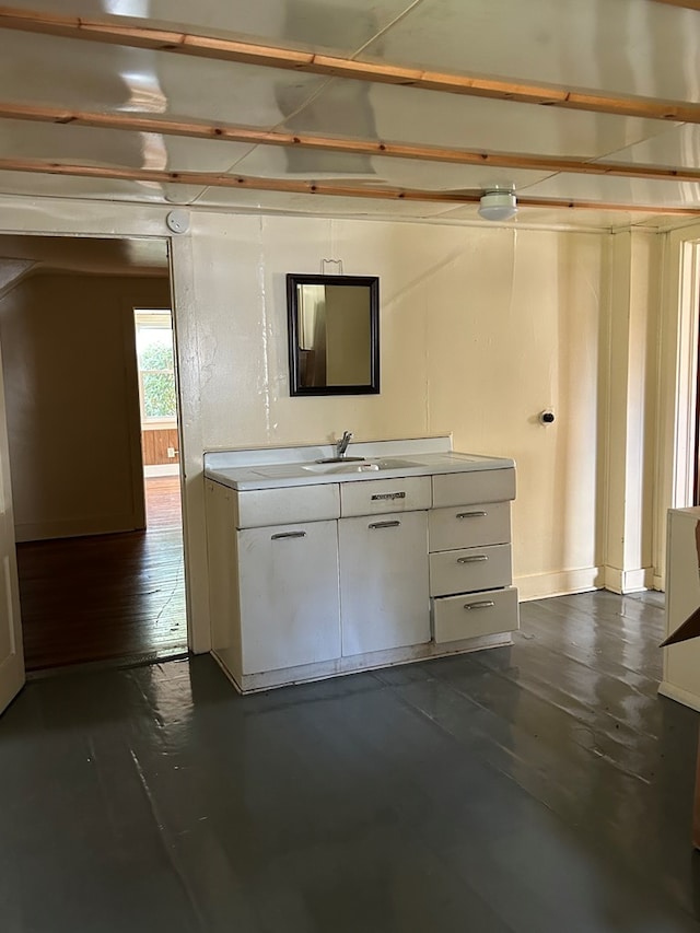 interior space featuring white cabinetry and sink