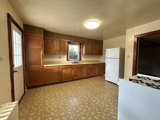 kitchen featuring sink and white appliances