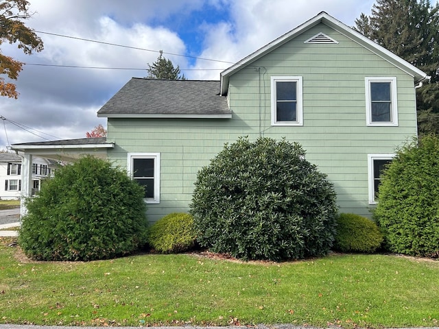 view of side of home featuring a lawn