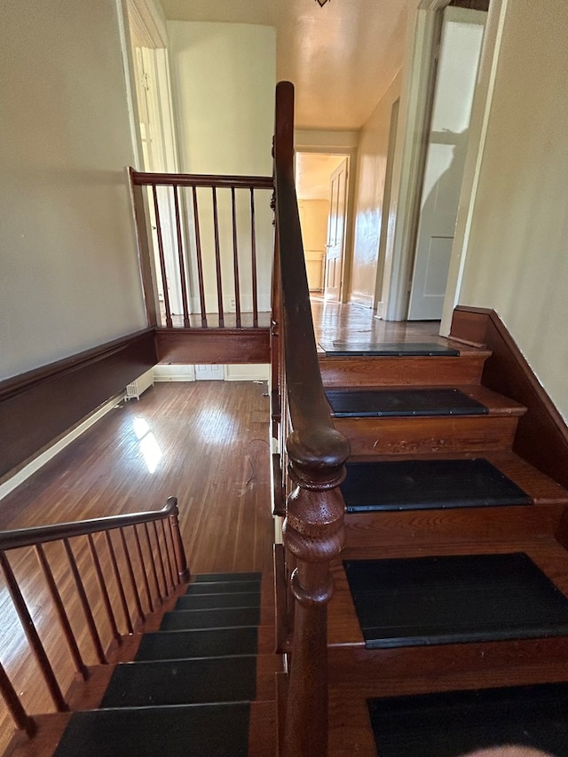 stairs with hardwood / wood-style floors