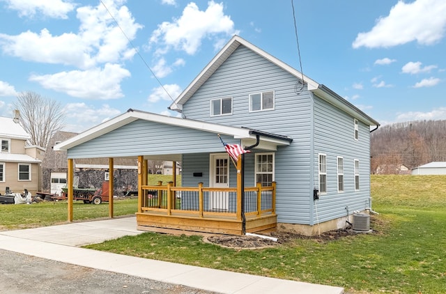 front facade with covered porch, central AC, and a front yard