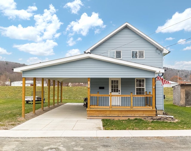 view of front of property with a carport, a porch, and a front yard