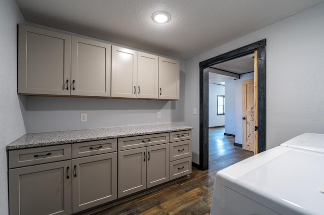 17899 Rte 6, Towanda, PA 18848 - laundry area with cabinet space, washer and dryer, dark wood-style flooring, a textured ceiling, and baseboards