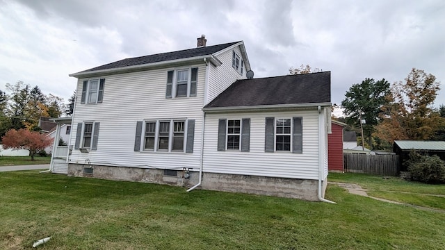 back of house featuring a yard