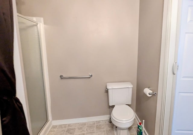 bathroom with walk in shower and toilet