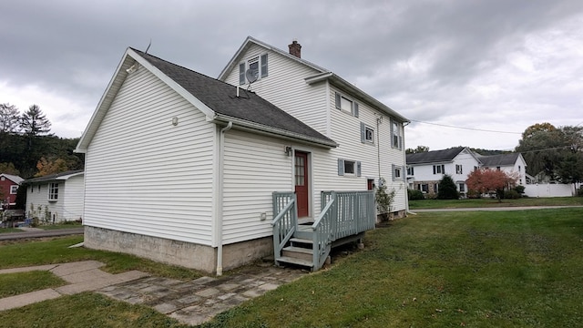 view of side of property with a lawn