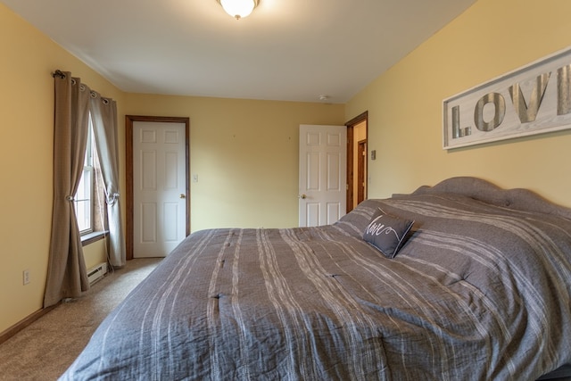 carpeted bedroom with a baseboard heating unit