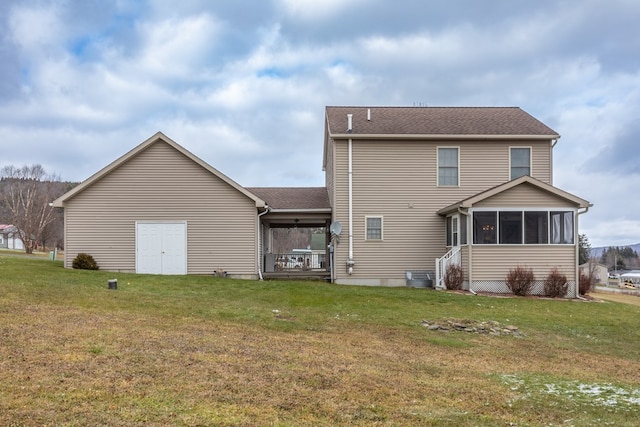 back of property featuring a yard and a sunroom