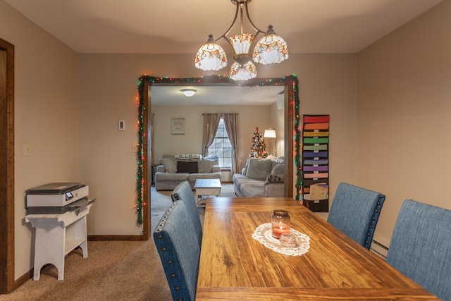 dining area featuring baseboard heating, light carpet, and a chandelier