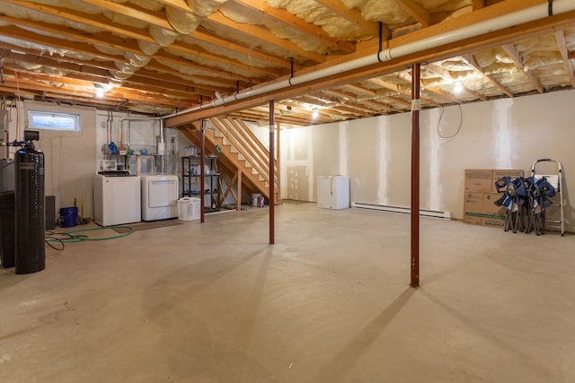 basement featuring washer and clothes dryer and a baseboard heating unit