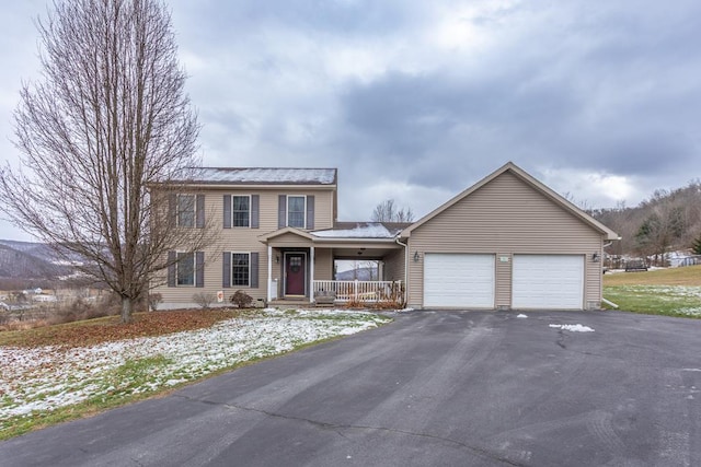 view of front property featuring a porch and a garage