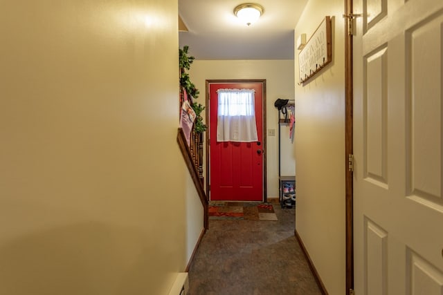 doorway to outside featuring dark carpet