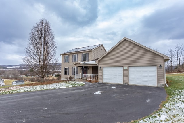 view of front of property featuring a garage and covered porch