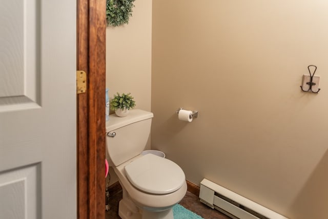 bathroom with baseboard heating and toilet