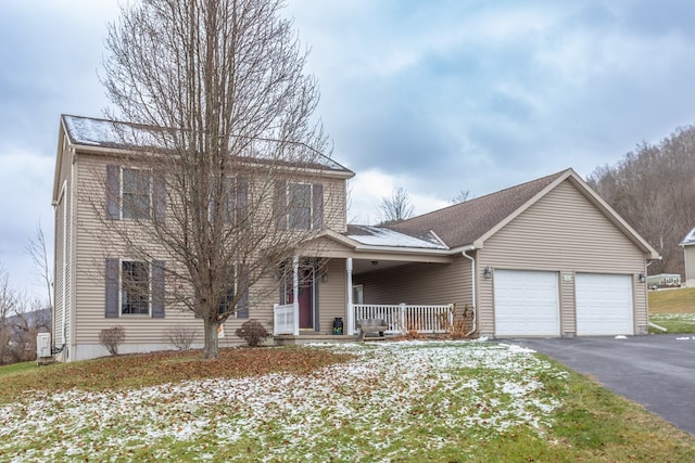 view of front of home with covered porch and a garage