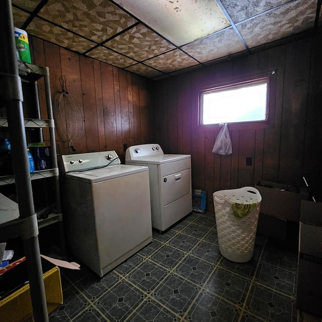 laundry room with separate washer and dryer and wooden walls