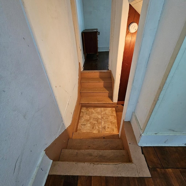 staircase with hardwood / wood-style flooring