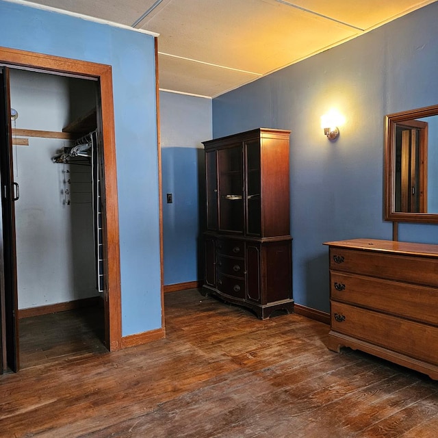 bedroom featuring a closet and dark wood-type flooring