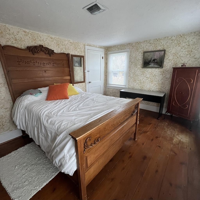 bedroom featuring dark hardwood / wood-style flooring