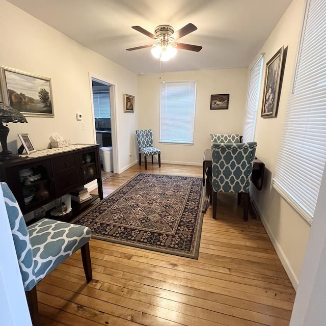 sitting room featuring ceiling fan, light hardwood / wood-style floors, and a wealth of natural light