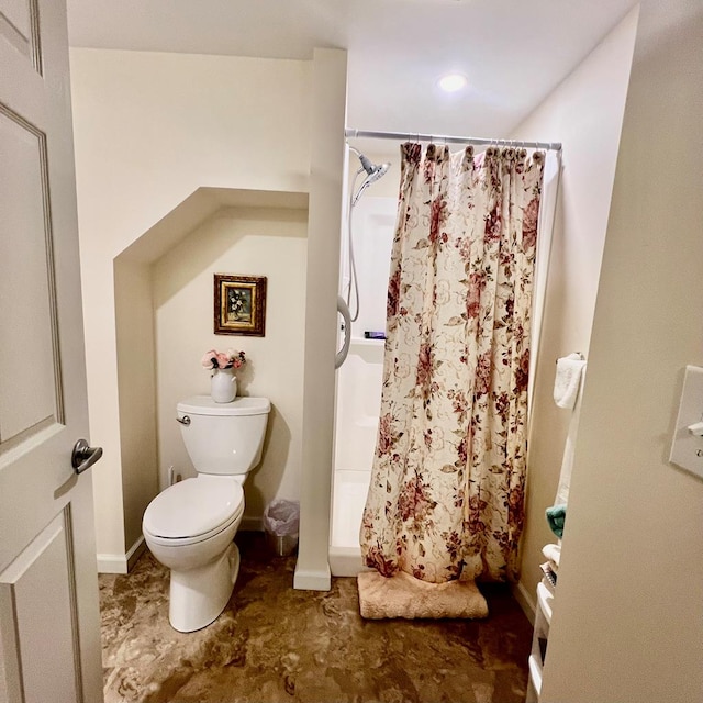 bathroom with a shower with curtain and toilet