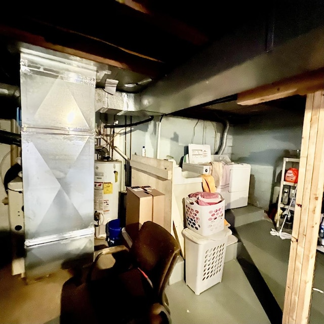 interior space with gas water heater, washing machine and dryer, and heating unit