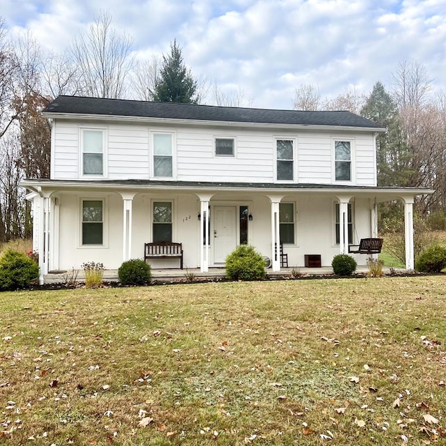 view of front of property with a porch and a front lawn