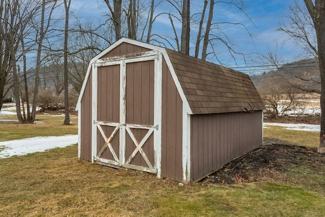 view of outbuilding with a yard