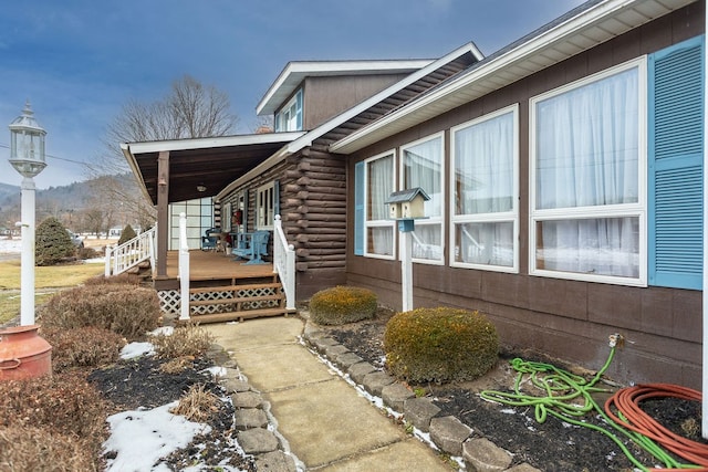 view of side of property featuring covered porch