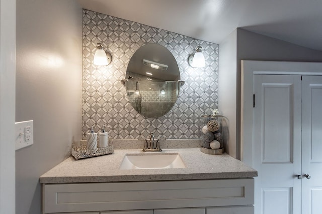 bathroom with vanity and a shower