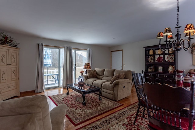 living room featuring a chandelier and light hardwood / wood-style flooring