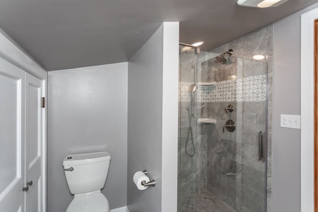 bathroom with toilet and a shower with shower door