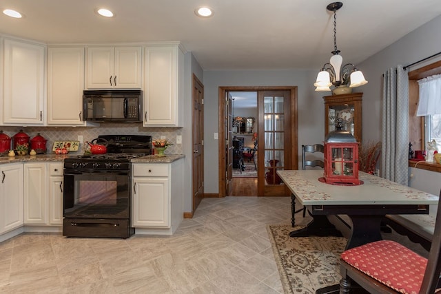 kitchen with light stone counters, decorative light fixtures, black appliances, and white cabinets