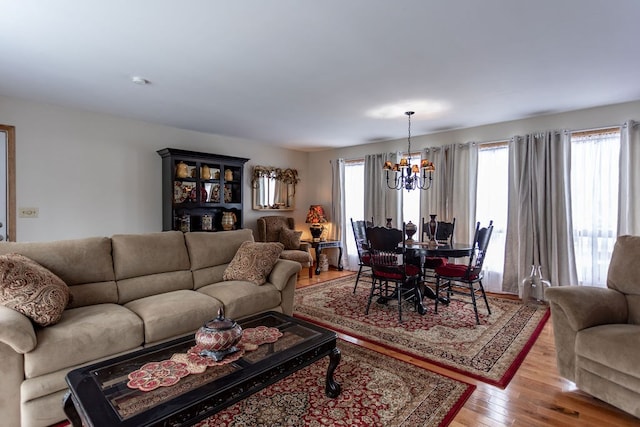 living room with a chandelier and light hardwood / wood-style floors