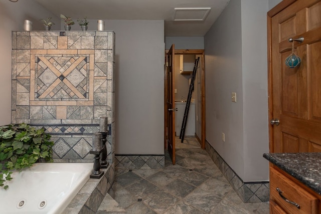 bathroom with vanity and tiled bath