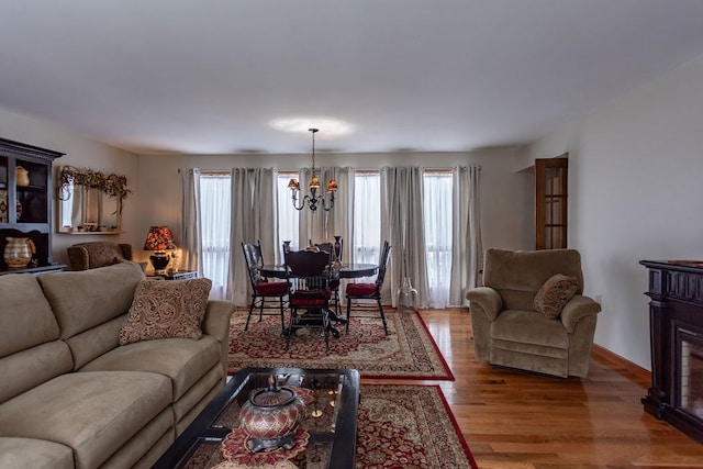 living room featuring wood-type flooring and a notable chandelier