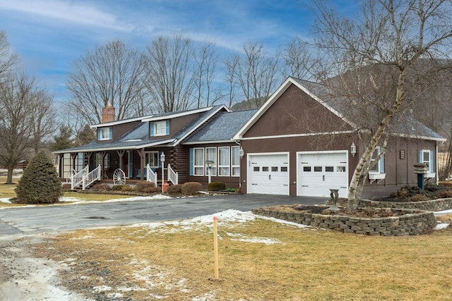 view of front facade with a garage, a front yard, and a porch