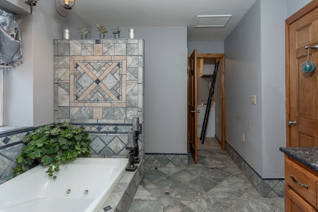 bathroom with vanity and tiled bath