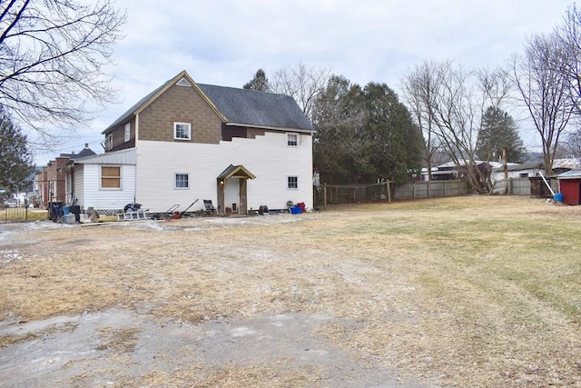 rear view of house featuring a lawn